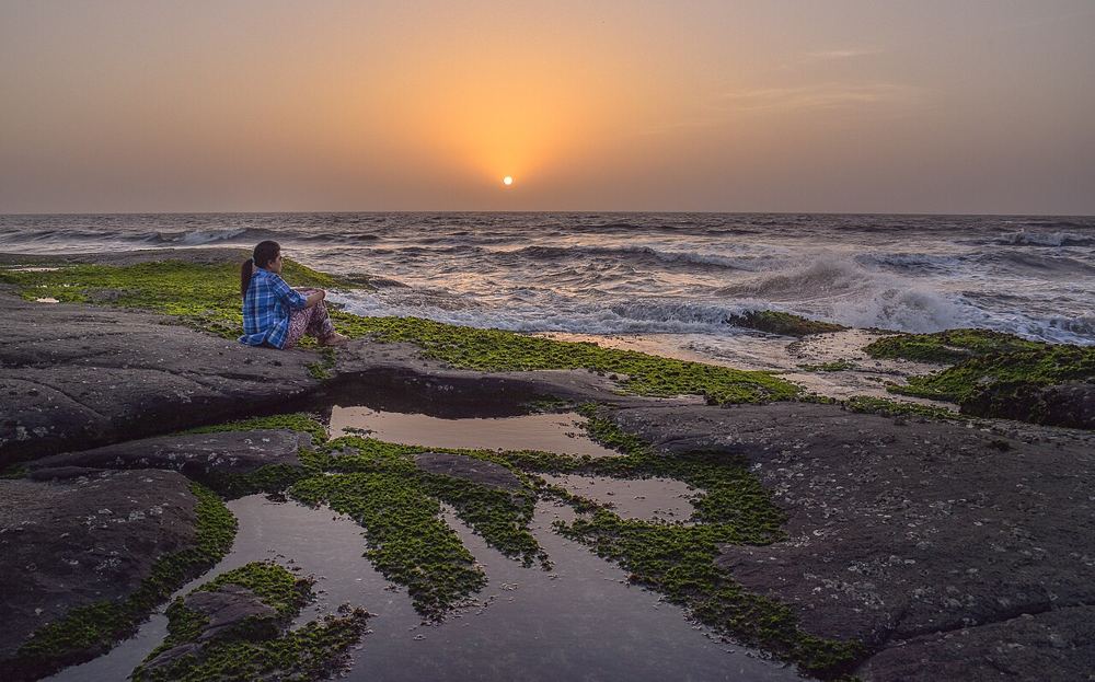Sunset over the rocky shore at Harihareshwar